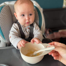 Load image into Gallery viewer, A new mom gives weaning food in a food masher bowl to a baby girl sitting in a high chair.