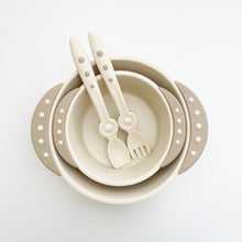 Load image into Gallery viewer, A 8 ounce beige bowl is in a 16 oz beige bowl. Stay clean baby spoon and fork are in the bowls with side handles.