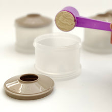 Load image into Gallery viewer, Detachable spout next to formula container. Pouring a scoopful of infant formula into container.