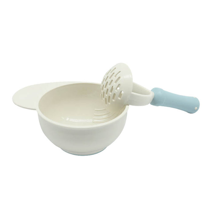 A blue baby food masher is with food Masher bowl with blue nonslip base.