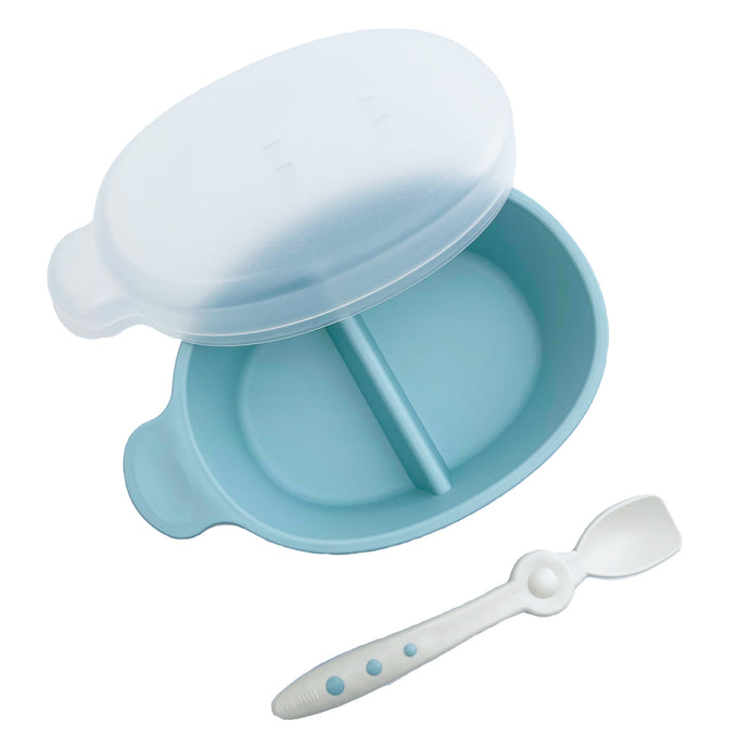 Blue sectioned bowl has a lid and spoon is attachable to the lid.