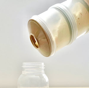 Baby formula inside formula container is poured into baby bottle.